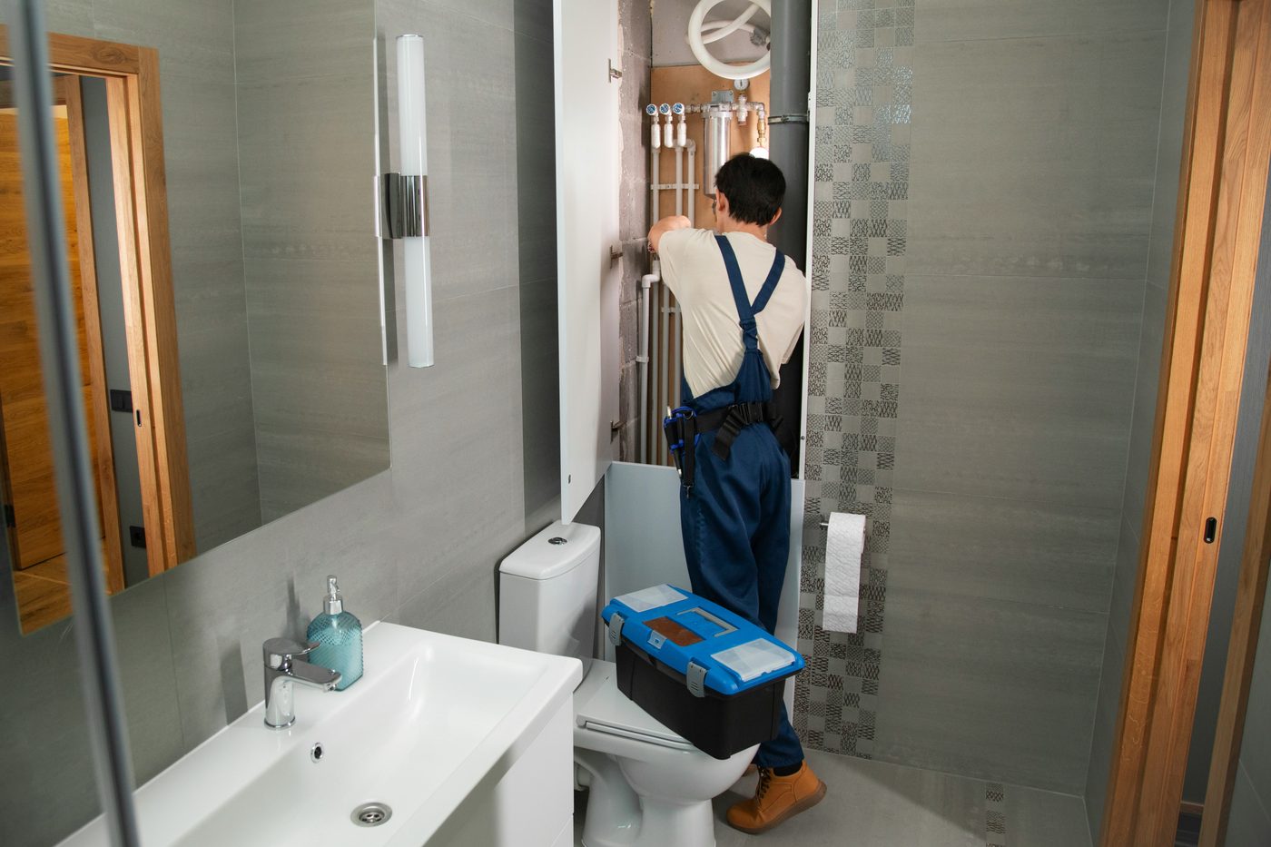 CareMax technician repairing bathroom plumbing