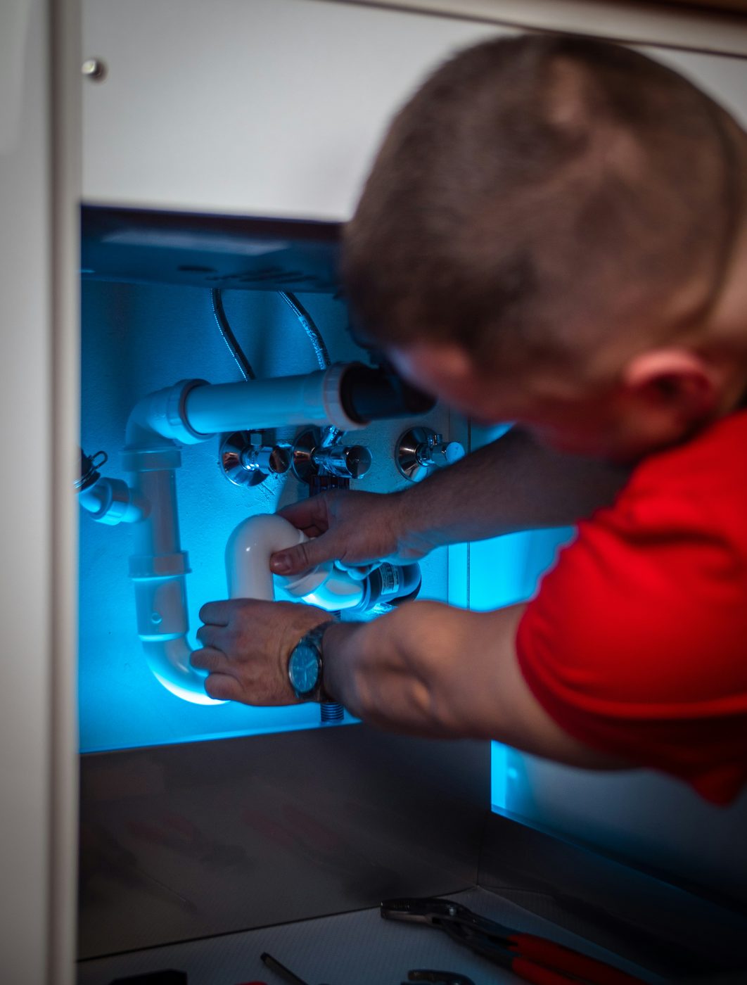 Pipework being fitted inside a cabinet